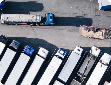 A photo shows aerial view of a row of parked trucks.